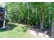 Private backyard with established trees, a firepit and bench at 59 Creekside Blf, Hiram, GA 30141