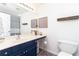 Stylish bathroom with a navy vanity, a mirror, and modern fixtures and finishes at 59 Creekside Blf, Hiram, GA 30141