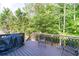 Outdoor deck featuring a grill, chairs, and a wooded view at 59 Creekside Blf, Hiram, GA 30141