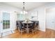 Cozy dining area features a modern table set, natural lighting, and access to the backyard at 59 Creekside Blf, Hiram, GA 30141
