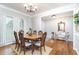 Elegant dining room with hardwood floors, decorative lighting, and ample natural light at 59 Creekside Blf, Hiram, GA 30141