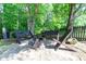 Backyard firepit area surrounded by bench seating and green foliage at 59 Creekside Blf, Hiram, GA 30141