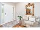 Inviting foyer featuring hardwood floors, a decorative mirror, and a bright white front door at 59 Creekside Blf, Hiram, GA 30141