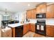 Well-lit kitchen with stainless steel appliances and wood cabinets, seamlessly merging into a cozy dining area at 59 Creekside Blf, Hiram, GA 30141
