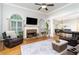 Open-concept living room with a stone fireplace, hardwood floors, and large windows at 59 Creekside Blf, Hiram, GA 30141