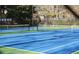 Bright blue and green community tennis court with well-maintained nets and fences at 59 Creekside Blf, Hiram, GA 30141