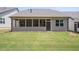 Screened-in back porch overlooks a well-maintained backyard, providing a relaxing outdoor space at 1409 Bluffs Ridge Way, Canton, GA 30114