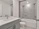 Modern bathroom with a gray vanity, quartz countertop, and white marble tiled shower at 1409 Bluffs Ridge Way, Canton, GA 30114