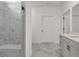 Bathroom showcasing marble tile, a glass-enclosed shower with bench, and modern vanity at 1409 Bluffs Ridge Way, Canton, GA 30114