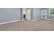 Bedroom with plush carpeting, gray walls, and access to the outdoors at 1409 Bluffs Ridge Way, Canton, GA 30114