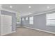 Well-lit bedroom featuring plush carpeting, gray walls, and white trim at 1409 Bluffs Ridge Way, Canton, GA 30114