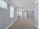 Spacious bedroom featuring neutral paint, plush carpet, and abundant natural light from large windows at 1409 Bluffs Ridge Way, Canton, GA 30114