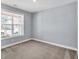 Bright bedroom with a large window providing natural light, and neutral color scheme at 1409 Bluffs Ridge Way, Canton, GA 30114