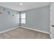 Cozy bedroom with plush carpeting and a window providing natural light at 1409 Bluffs Ridge Way, Canton, GA 30114