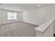Large bonus room with carpeted flooring, a window, and modern finishes at 1409 Bluffs Ridge Way, Canton, GA 30114