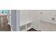 View of hallway featuring wood flooring with a built-in bench, shelves, and a door leading to the laundry room at 1409 Bluffs Ridge Way, Canton, GA 30114