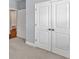 Hallway closet featuring paneled doors and bronze hardware at 1409 Bluffs Ridge Way, Canton, GA 30114