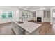 Spacious kitchen island with sink overlooks the living room with fireplace and built-in shelving at 1409 Bluffs Ridge Way, Canton, GA 30114
