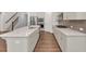 Stylish kitchen with a quartz countertop island, sleek cabinets, and stainless steel appliances at 1409 Bluffs Ridge Way, Canton, GA 30114
