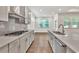 Modern kitchen with stainless steel appliances, gas cooktop, and gray herringbone backsplash at 1409 Bluffs Ridge Way, Canton, GA 30114