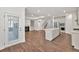 Open-concept living room with wood floors, a fireplace, and plenty of natural light at 1409 Bluffs Ridge Way, Canton, GA 30114