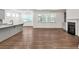 Open-concept living area with hardwood floors, bright windows, and a stylish fireplace at 1409 Bluffs Ridge Way, Canton, GA 30114