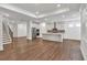 Expansive open-concept design with hardwood floors, stairs, and a modern kitchen at 1409 Bluffs Ridge Way, Canton, GA 30114