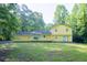 Expansive backyard view featuring a two story home and lush greenery at 2037 Cliffton Ter, Snellville, GA 30039