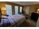 Bedroom with neutral walls, a queen-size bed, and large windows providing plenty of natural light at 2037 Cliffton Ter, Snellville, GA 30039