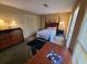 Cozy bedroom featuring a queen-size bed, dresser, and ample natural light from the windows at 2037 Cliffton Ter, Snellville, GA 30039