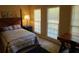 Bedroom features a queen-size bed, dark wood furnishings, and large windows for plenty of light at 2037 Cliffton Ter, Snellville, GA 30039