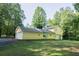 Two-story house with attached garage, set against a backdrop of mature trees and a well-maintained lawn at 2037 Cliffton Ter, Snellville, GA 30039