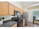 Well-lit kitchen showcasing stainless steel appliances and modern countertops at 3705 Tate Pl, Austell, GA 30106
