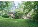 A view of the spacious backyard with a lush green lawn and mature trees, creating a private outdoor space at 4236 Beaver Ruin Nw Ct, Lilburn, GA 30047