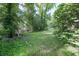 A view of the spacious backyard with a lush green lawn and mature trees, creating a private outdoor space at 4236 Beaver Ruin Nw Ct, Lilburn, GA 30047