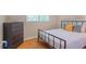 Comfortable bedroom with natural light, a bed with grey and yellow pillows, and hardwood floors at 4236 Beaver Ruin Nw Ct, Lilburn, GA 30047