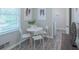 Bright dining area featuring a round table, modern chairs, and a window letting in natural light at 4236 Beaver Ruin Nw Ct, Lilburn, GA 30047
