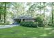 Charming single-story brick home with lush green lawn and mature trees, offering a serene and private setting at 4236 Beaver Ruin Nw Ct, Lilburn, GA 30047