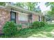 Cozy brick home with manicured bushes and vines adding to its inviting charm at 4236 Beaver Ruin Nw Ct, Lilburn, GA 30047