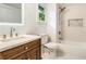 Modern bathroom features marble countertop, bathtub, shower, and a window with lush greenery views at 481 Glenwood Se Ave, Atlanta, GA 30312