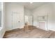 Bright bedroom features light hardwood floors, a fireplace, and a doorway leading to another room at 481 Glenwood Se Ave, Atlanta, GA 30312