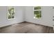 Sunlit bedroom features light hardwood floors and two large windows with green leafy views at 481 Glenwood Se Ave, Atlanta, GA 30312