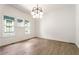 Sunlit dining area with hardwood floors, a modern chandelier, and large windows offering neighborhood views at 481 Glenwood Se Ave, Atlanta, GA 30312