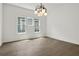 Well-lit dining space featuring hardwood floors, large windows, and a modern light fixture at 481 Glenwood Se Ave, Atlanta, GA 30312