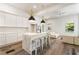 Bright living room adjacent to the kitchen, featuring hardwood floors, white walls, and a center island at 481 Glenwood Se Ave, Atlanta, GA 30312