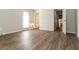 Neutral-toned bedroom features modern vinyl plank flooring and an exit door, creating a relaxing and versatile space at 5243 Valleyview Dr, Acworth, GA 30102