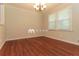 Dining room featuring hardwood floors, a classic chandelier, and bright natural light from the large windows at 5243 Valleyview Dr, Acworth, GA 30102