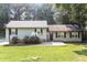 Charming single-story home with light siding, black shutters, and a well-maintained front yard with mature trees at 5243 Valleyview Dr, Acworth, GA 30102