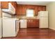 Functional kitchen with white appliances, wood cabinets, and hardwood floors provides a practical cooking environment at 5243 Valleyview Dr, Acworth, GA 30102