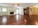 Bright living room featuring hardwood floors, a fireplace, and an open layout connecting to the kitchen and dining area at 5243 Valleyview Dr, Acworth, GA 30102